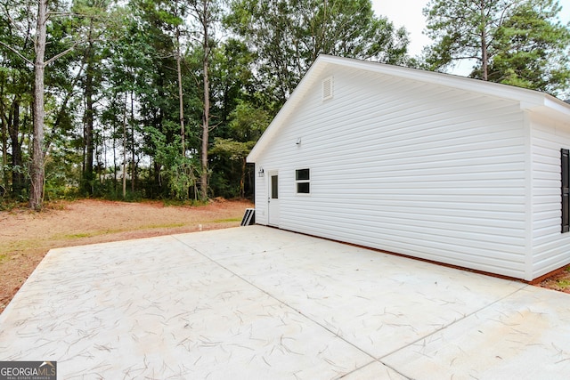 view of side of home with a patio area