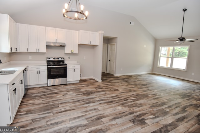 kitchen with white cabinets, hardwood / wood-style floors, ceiling fan with notable chandelier, appliances with stainless steel finishes, and pendant lighting