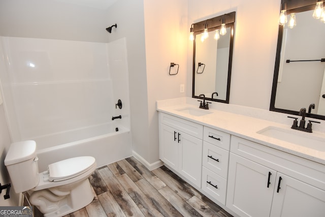 full bathroom featuring vanity, toilet, hardwood / wood-style floors, and bathtub / shower combination