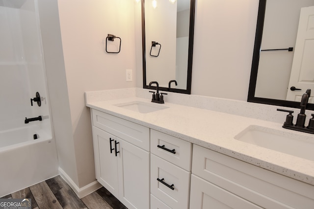 bathroom featuring shower / bath combination, hardwood / wood-style flooring, and vanity