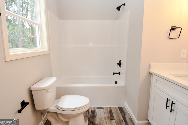 full bathroom with wood-type flooring, toilet, tub / shower combination, and vanity