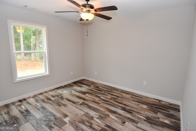 spare room with ceiling fan, hardwood / wood-style flooring, and plenty of natural light