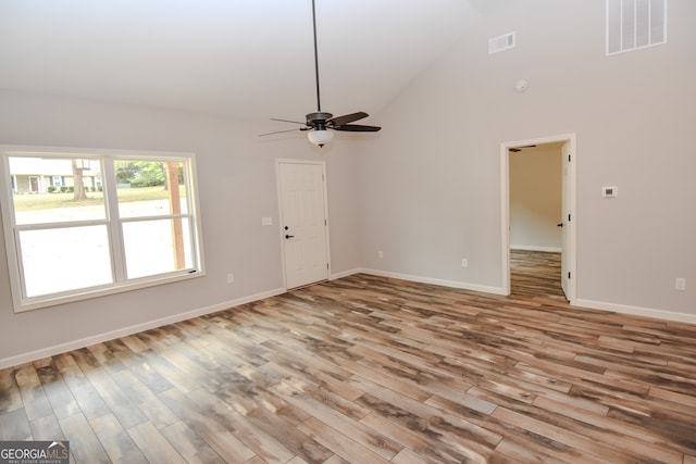 unfurnished living room featuring light wood-type flooring, high vaulted ceiling, and ceiling fan