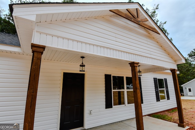 view of exterior entry featuring a porch