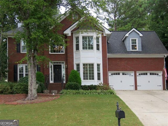 view of front facade featuring a front lawn and a garage