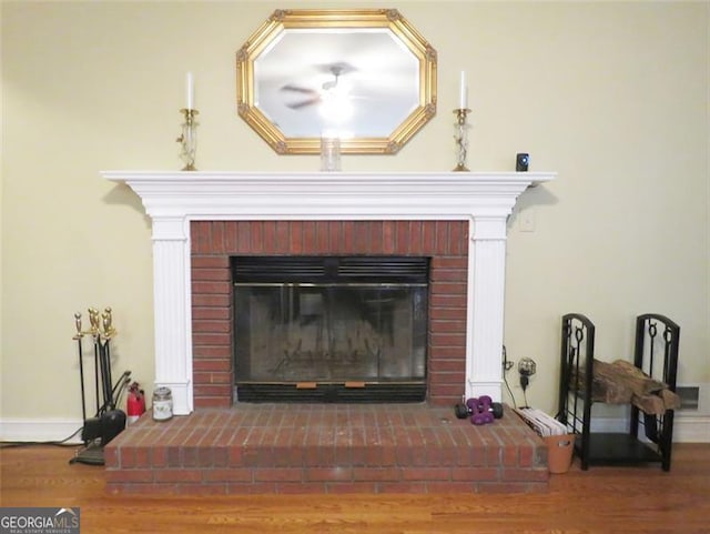 interior details with wood-type flooring and a fireplace