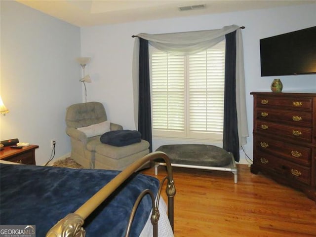 bedroom with wood-type flooring