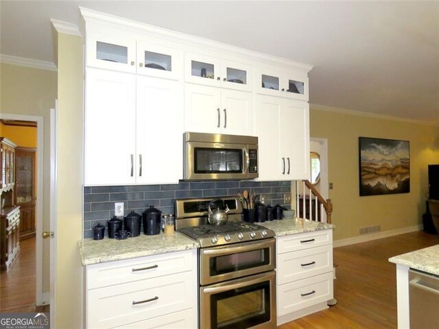 kitchen with sink, white cabinets, hanging light fixtures, and dishwasher