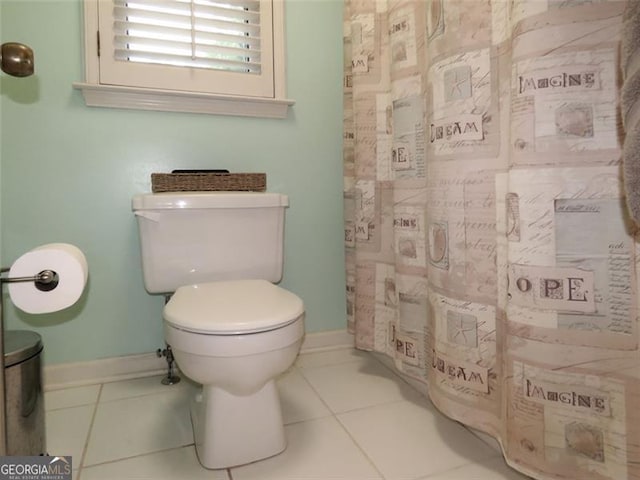 bathroom featuring toilet and tile patterned flooring