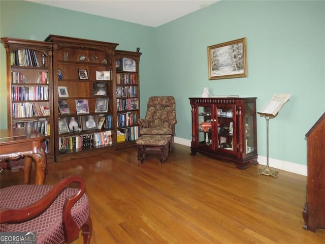 sitting room with hardwood / wood-style floors