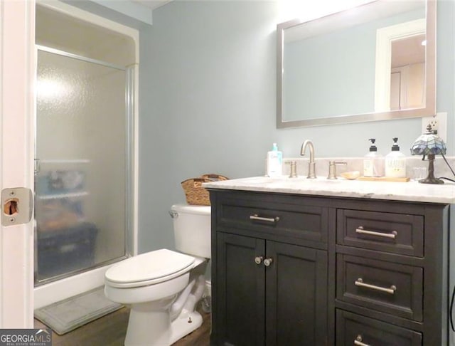 bathroom with vanity, toilet, and walk in shower