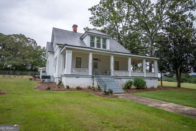 view of front of home featuring covered porch and a front yard