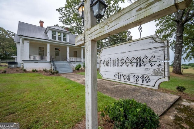 community sign featuring a yard