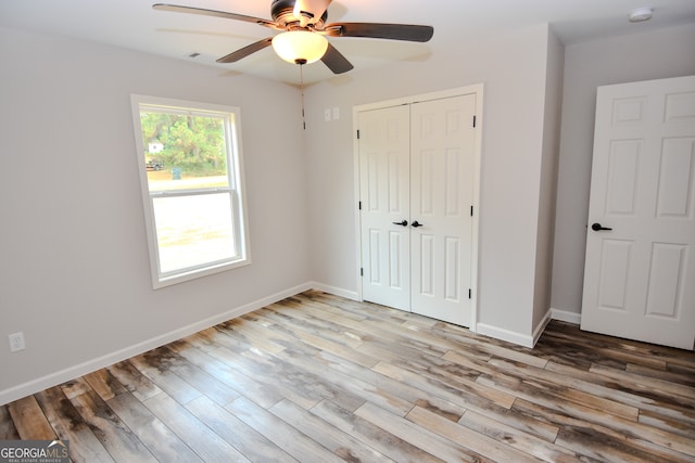 unfurnished bedroom featuring a closet, ceiling fan, and light hardwood / wood-style floors