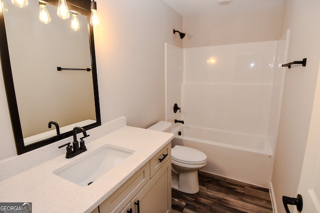 full bathroom with vanity, toilet, hardwood / wood-style floors, and bathing tub / shower combination