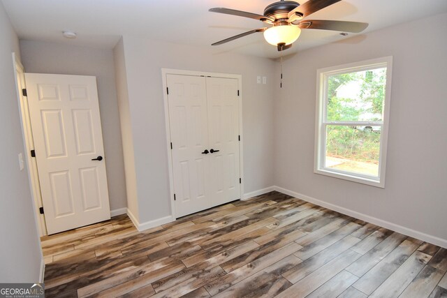 101 Alexandria Way, Thomaston, GA 30286 - unfurnished bedroom with wood finished floors, a closet, baseboards, and a ceiling fan