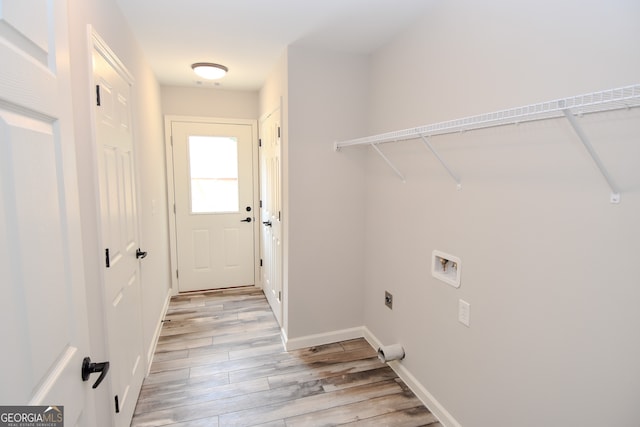 washroom with hookup for a washing machine, light hardwood / wood-style flooring, and electric dryer hookup