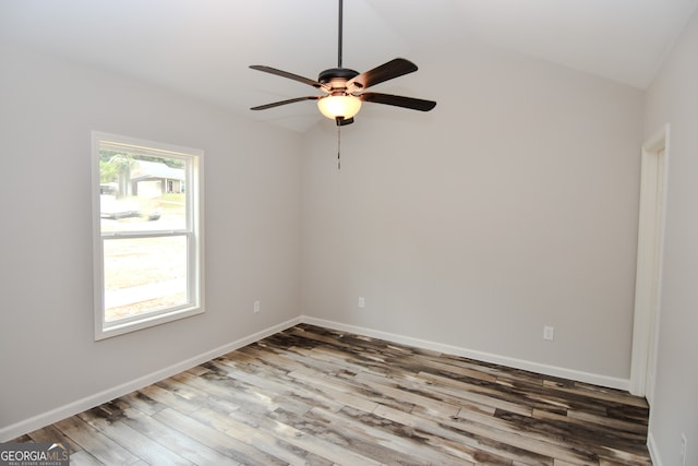 spare room featuring ceiling fan, hardwood / wood-style flooring, and vaulted ceiling