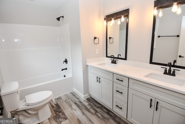 full bathroom with vanity, toilet, wood-type flooring, and shower / bath combination