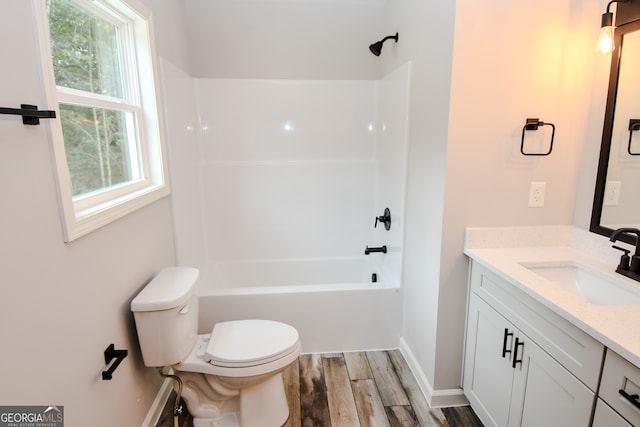 full bathroom featuring hardwood / wood-style floors, shower / bath combination, toilet, and vanity