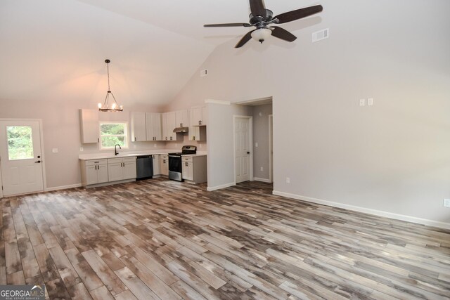 101 Alexandria Way, Thomaston, GA 30286 - unfurnished living room featuring wood finished floors, high vaulted ceiling, a ceiling fan, baseboards, and a chandelier