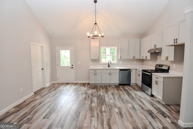 kitchen featuring plenty of natural light, stainless steel appliances, a notable chandelier, and white cabinetry