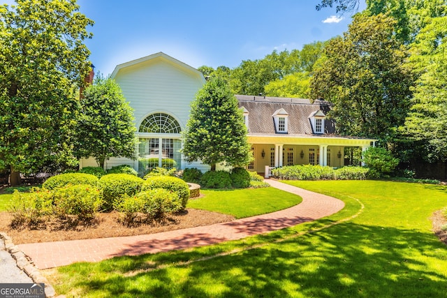 new england style home with a front lawn