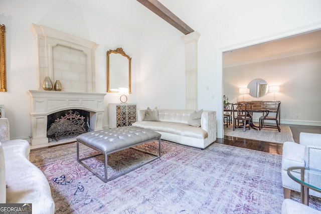 living room featuring beamed ceiling and wood-type flooring