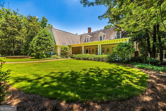 new england style home with a front lawn