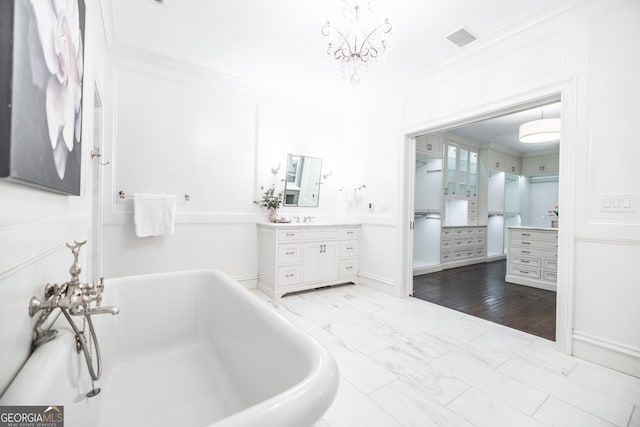 bathroom featuring crown molding, vanity, hardwood / wood-style floors, and a bathing tub