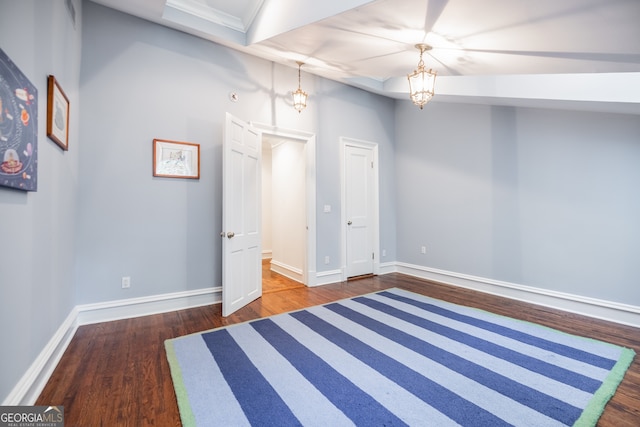 interior space featuring dark wood-type flooring and an inviting chandelier