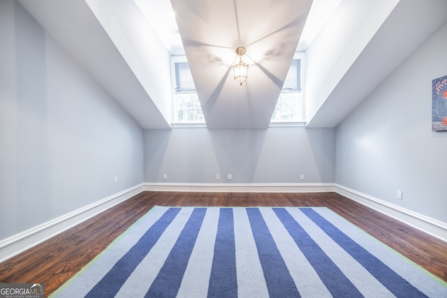 bonus room featuring plenty of natural light and dark hardwood / wood-style floors