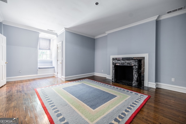 unfurnished living room with a high end fireplace, dark wood-type flooring, and ornamental molding