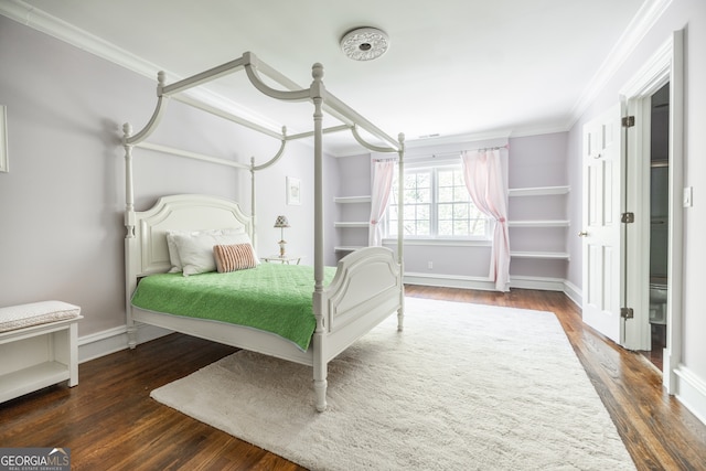 bedroom featuring crown molding and dark hardwood / wood-style flooring