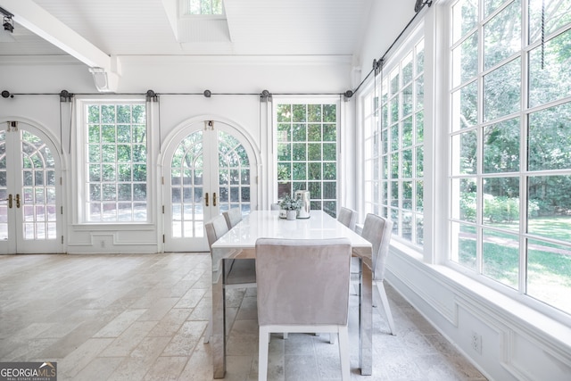 unfurnished sunroom featuring a wealth of natural light and french doors