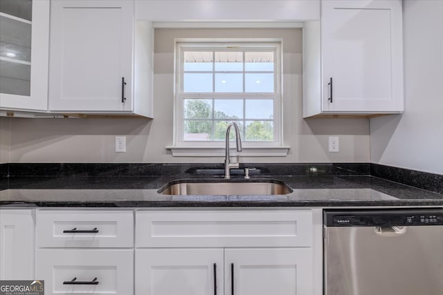 kitchen with dishwasher, white cabinetry, and sink