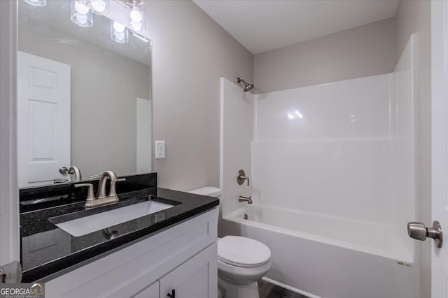 full bathroom featuring toilet, bathing tub / shower combination, and vanity