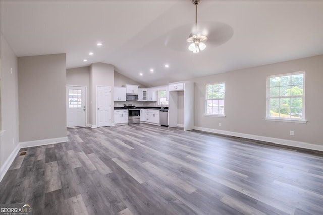 unfurnished living room with ceiling fan, vaulted ceiling, and hardwood / wood-style flooring