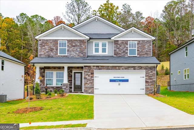 craftsman-style house with central AC unit, a garage, and a front yard