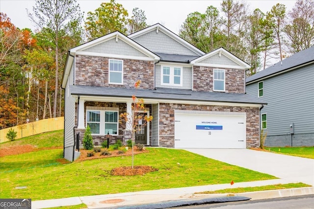 craftsman house featuring a front yard and a garage