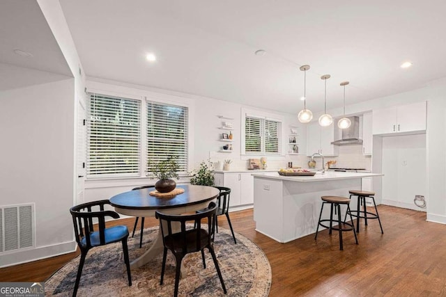 dining room featuring dark wood-type flooring, a wealth of natural light, and sink