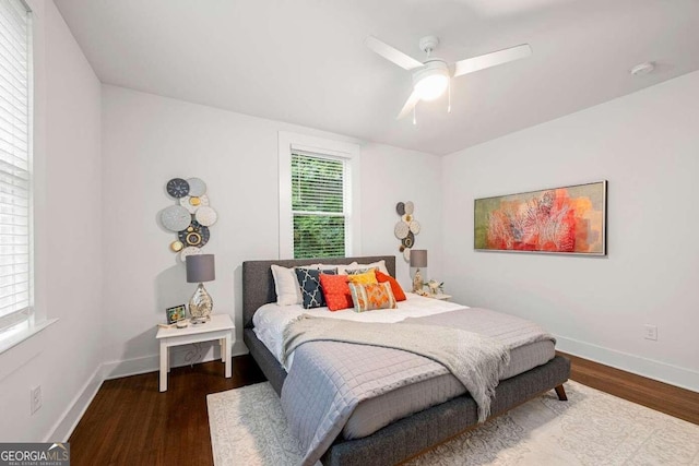 bedroom with ceiling fan and dark hardwood / wood-style floors