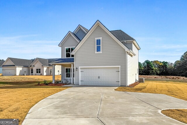 view of front of house featuring a front yard and a garage