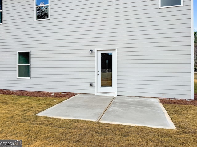 54 Charlie Fuller Rd Lot 3, Grantville, GA 30220 - view of exterior entry featuring a patio and a lawn