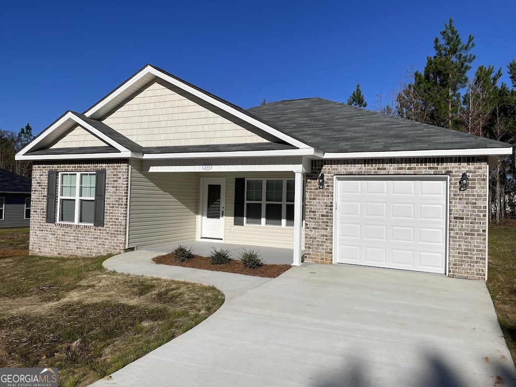 view of front of property with a garage and covered porch