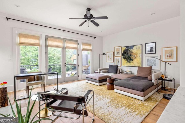 living room with hardwood / wood-style flooring, ceiling fan, a healthy amount of sunlight, and french doors