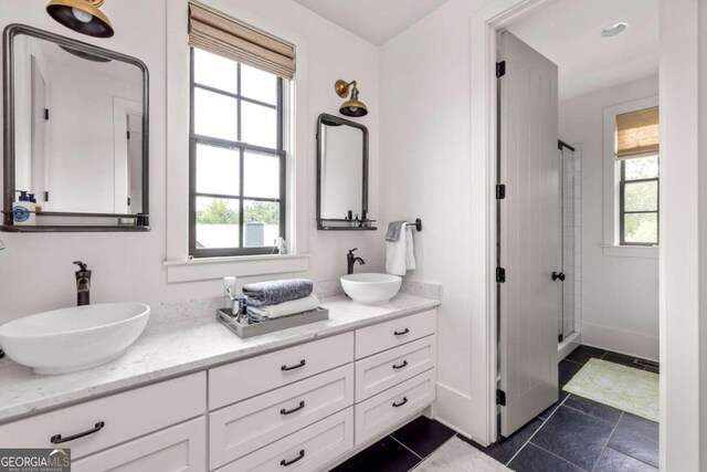 bathroom with vanity, tile patterned flooring, and a shower with door