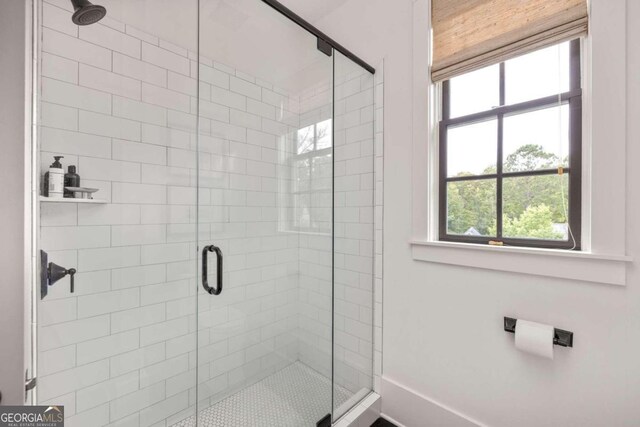 bathroom with a shower with shower door