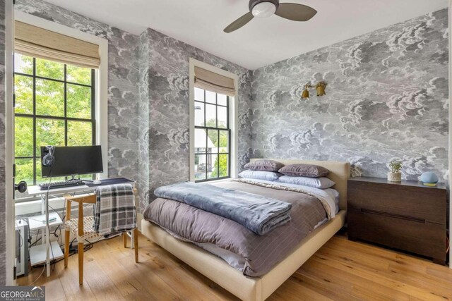 bedroom featuring light hardwood / wood-style floors and ceiling fan