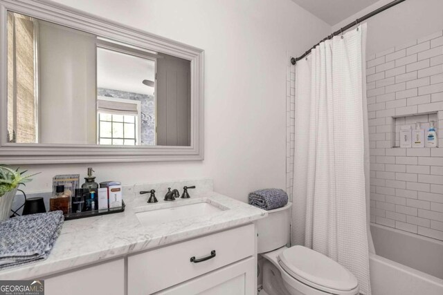 full bathroom featuring toilet, shower / bath combo, and vanity